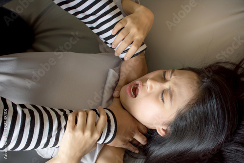 Portrait of thief strangle woman in bed,violence against women and criminal concept