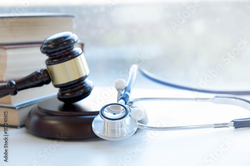 Gavel and stethoscope. medical jurisprudence. legal definition of medical malpractice. attorney. common errors doctors, nurses and hospitals make photo