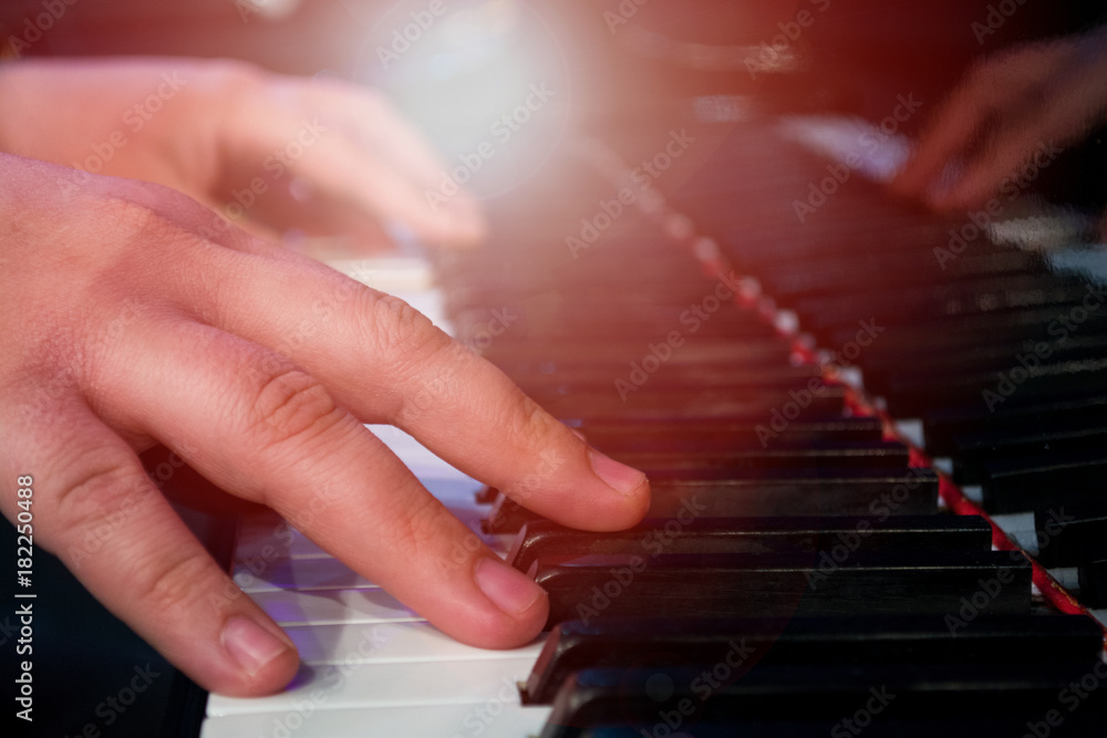 playing piano with light sunset background
