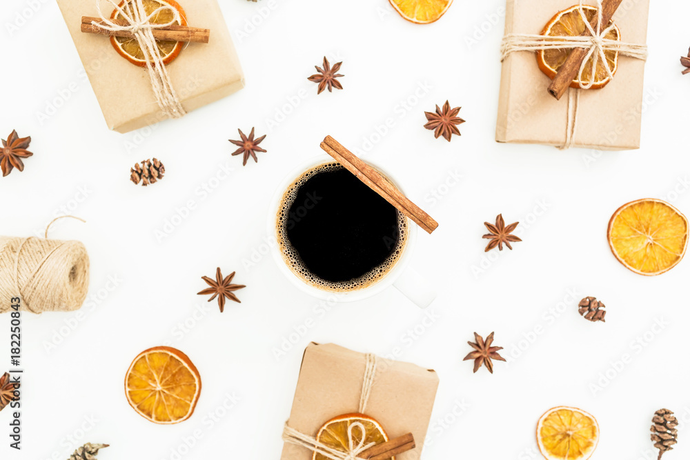 Christmas or New Year concept with gift box, mug of coffee, anise and citrus on white background. Flat lay, top view Christmas or New Year concept with gift box, mug of coffee, anise and citrus on white background. Flat lay, top view