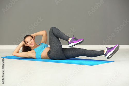 Sporty young woman training in gym