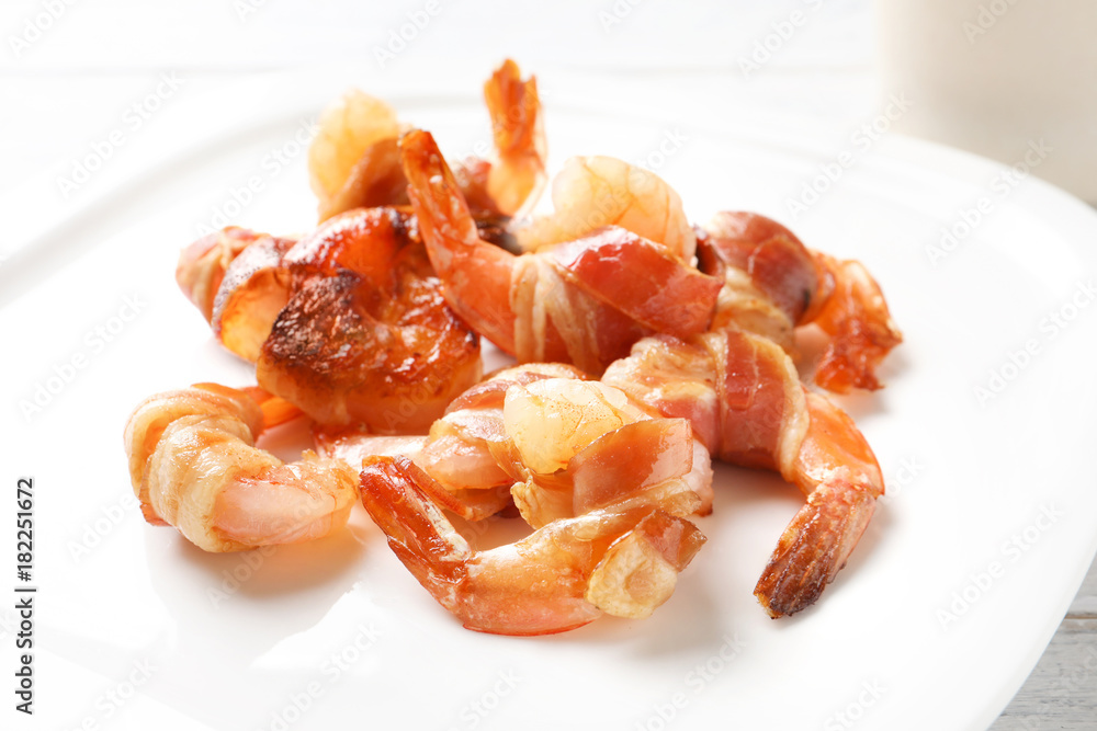 Shrimps wrapped in bacon on plate, closeup Shrimps wrapped in bacon on plate, closeup