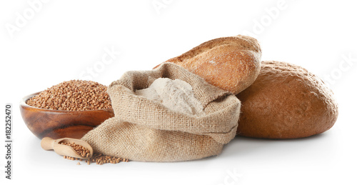 Composition with buckwheat flour and fresh bread on white background