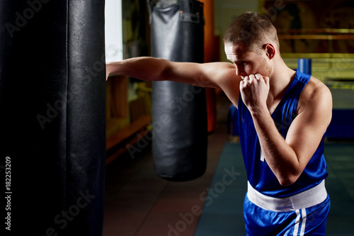 Boxing. Portrait of a boxer on the background of the gym