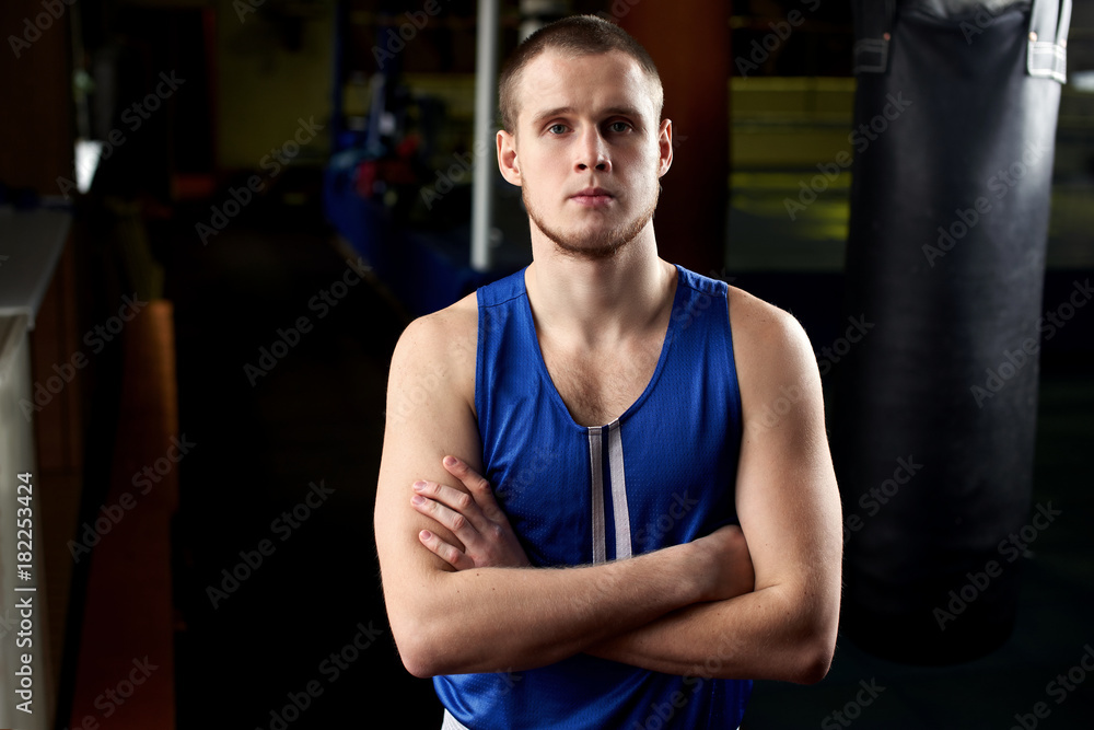 Boxing. Portrait of a boxer on the background of the gym Boxing. Portrait of a boxer on the background of the gym