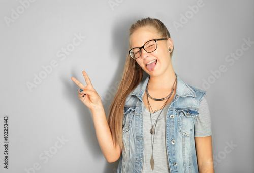 Cute teenager girl on grey ...