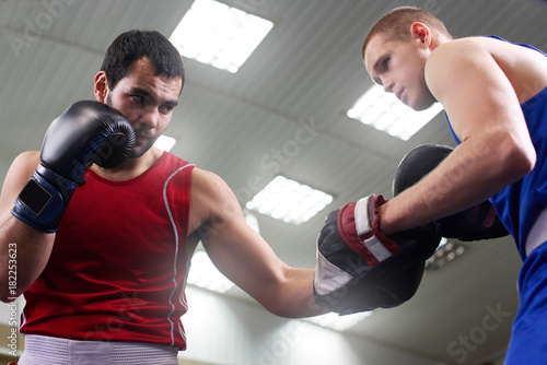 Boxing. Two guys boxer train in the gym