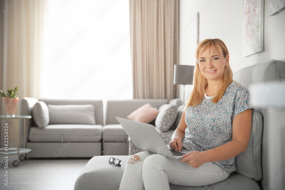 Beautiful mature woman with laptop at home Beautiful mature woman with laptop at home