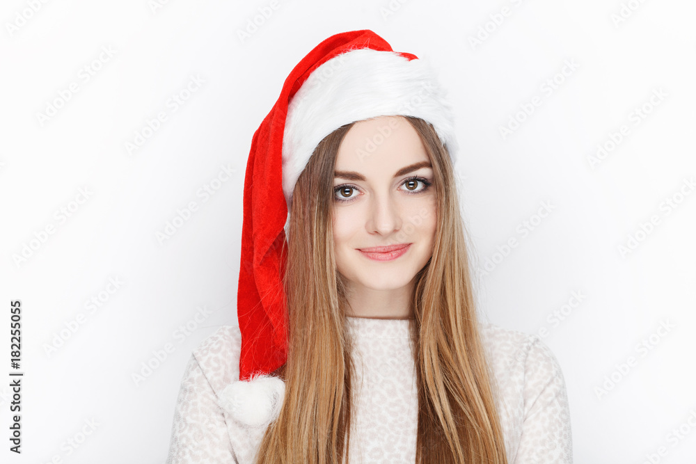 Beautiful emotional blonde female model wear Santa Claus hat. Christmas and happy new year greetings concept.