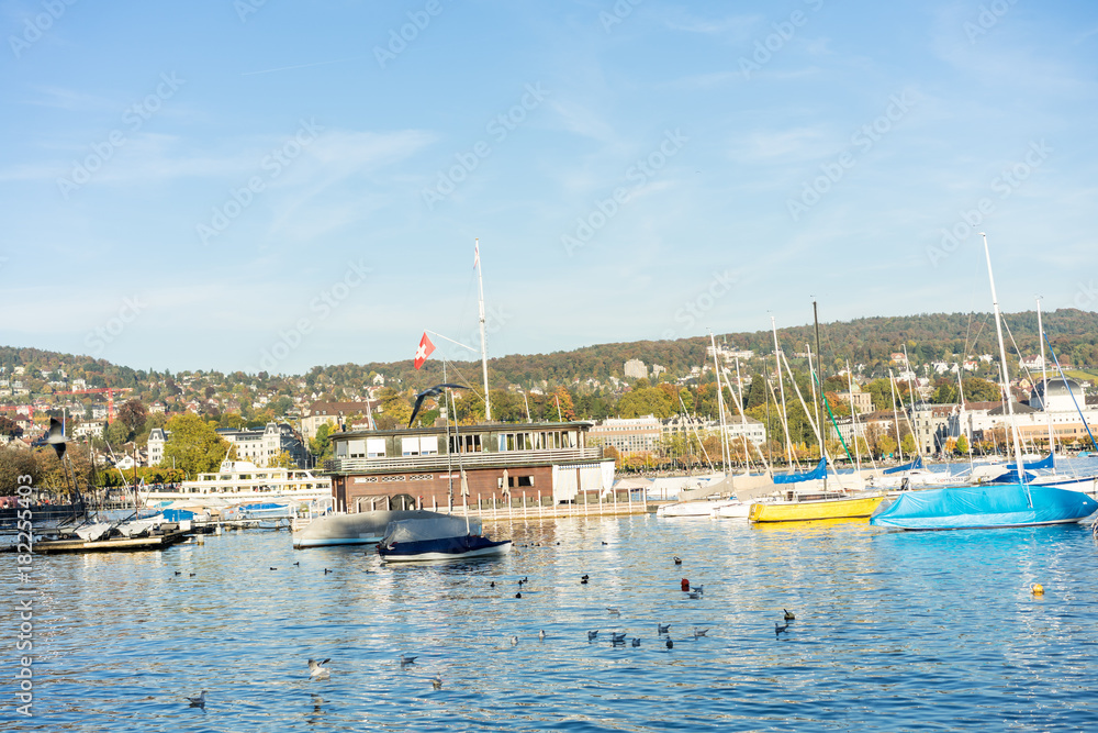 lake zurich with city buildings, boats and blue water