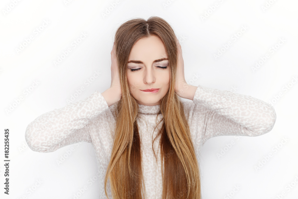 Beautiful emotional blonde female model wear pajamas cover her ears. Communication patterns concept. Beautiful emotional blonde female model wear pajamas cover her ears. Communication patterns concept.