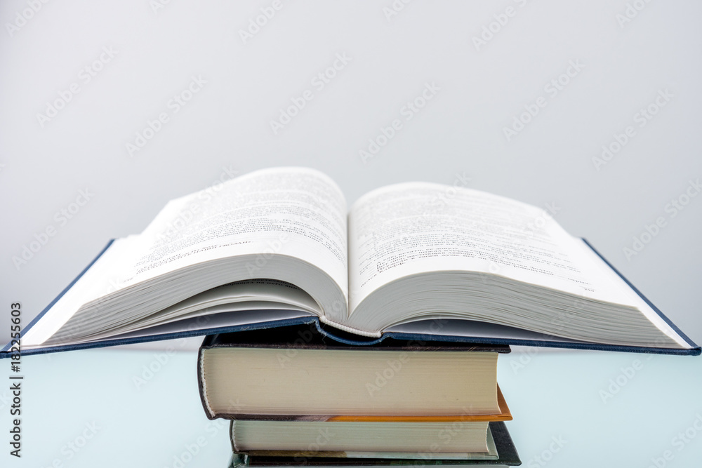 Education concept - books on the gray background Education concept - books on the gray background