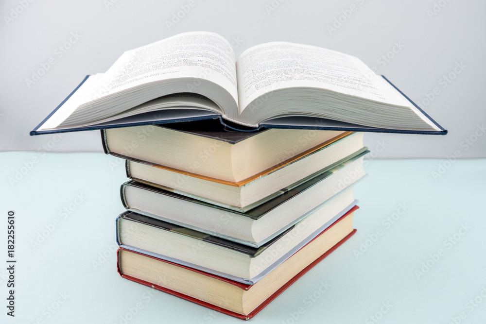 Education concept - books on the gray background Education concept - books on the gray background
