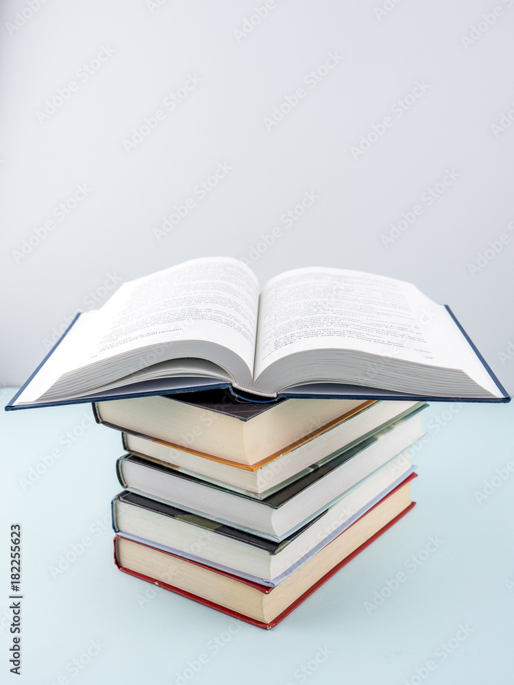 Education concept - books on the gray background Education concept - books on the gray background