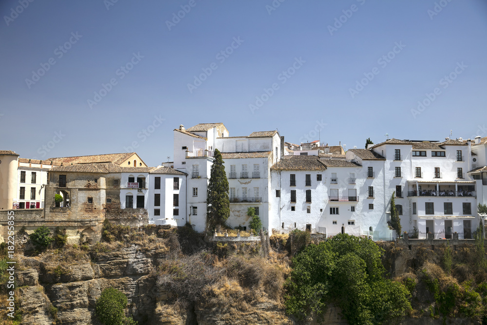 view from the mountain to the bridge, fields and houses. White houses in Spain. View of Ronda, Spanish Moor town - Ronda, Malaga, Andalusia, Spain