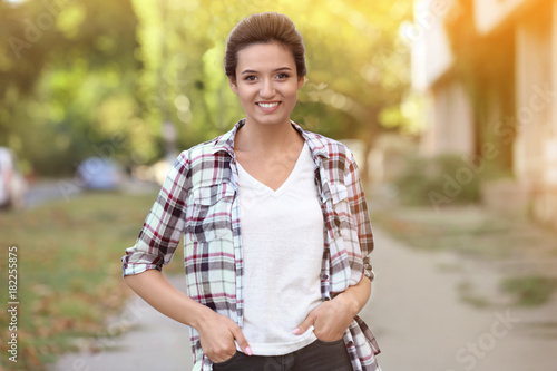 Smiling young woman in plai...