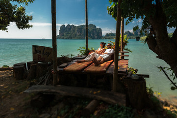 Couple in love on an island off the coast. Couple by the sea. Man and woman travel to beautiful places. Couple in love at the lagoon. Honeymoon trip. Relax on the island. Travel to Asia