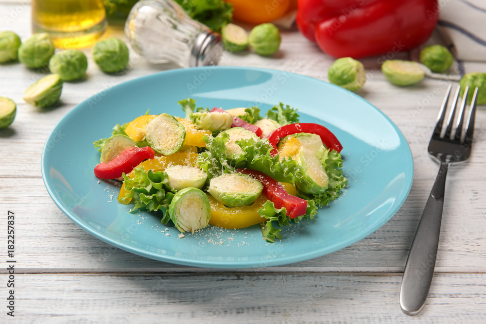 Plate of tasty salad with Brussels sprouts on table