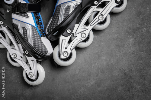 Pair of roller skates on grey background