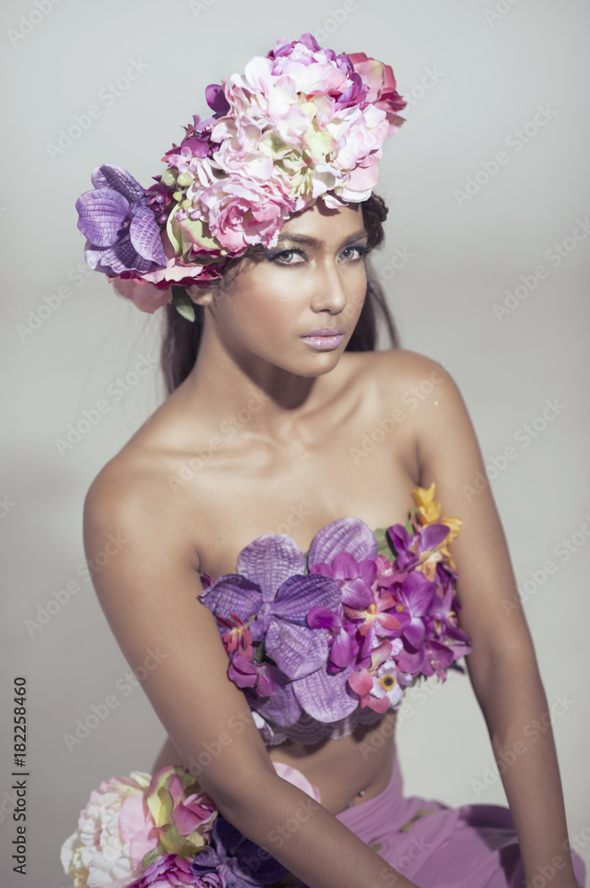 Young Asian Woman Tanned Skin And Black Shine Long Hair with flowers costume  design. Stock Photo | Adobe Stock