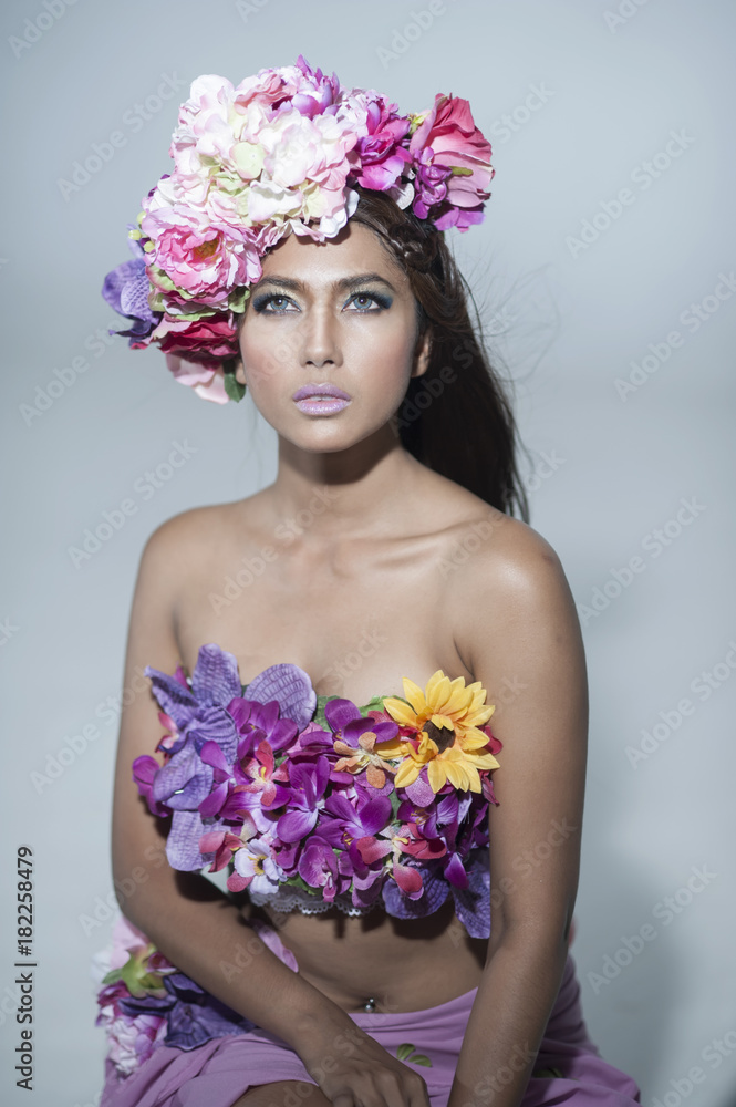 Young Asian Woman Tanned Skin And Black Shine Long Hair with flowers costume design.