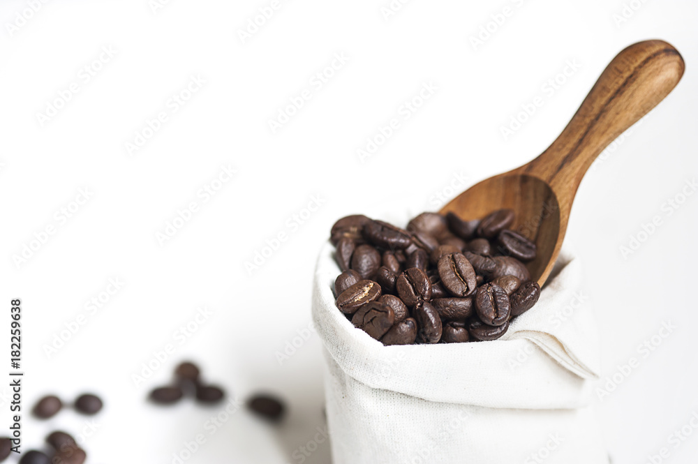 Fototapeta premium Coffee bean, wooden spoon and white sack