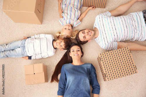 Happy family lying on floor...