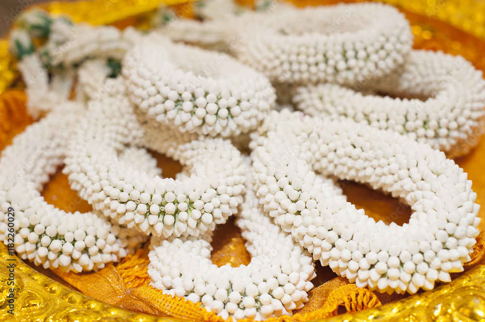 Thai traditional wedding accessories, white garland made from jasmin on golden tray