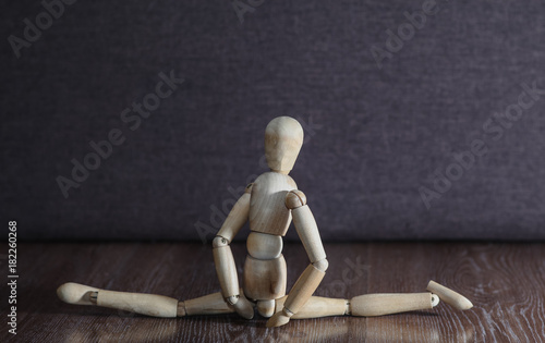 The girl does twine and demonstrates its flexibility. The concept. Wooden figure