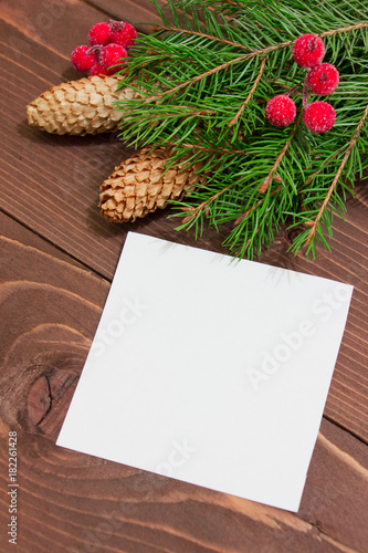 Christmas template-empty blank   tree branches  red berries and cones on wooden background  with decoration