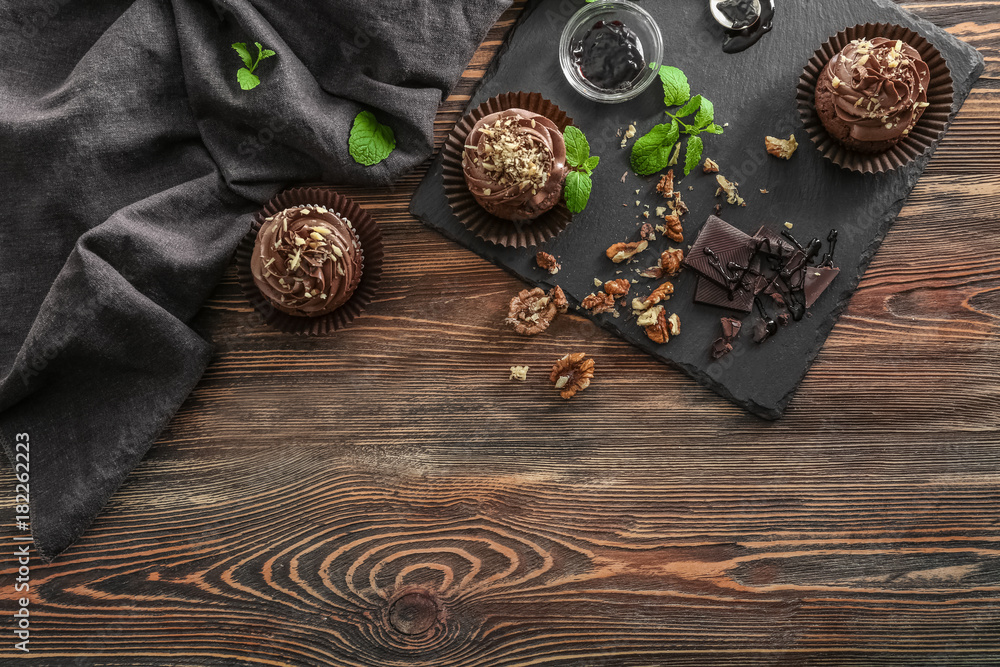 Composition with chocolate cupcakes on table