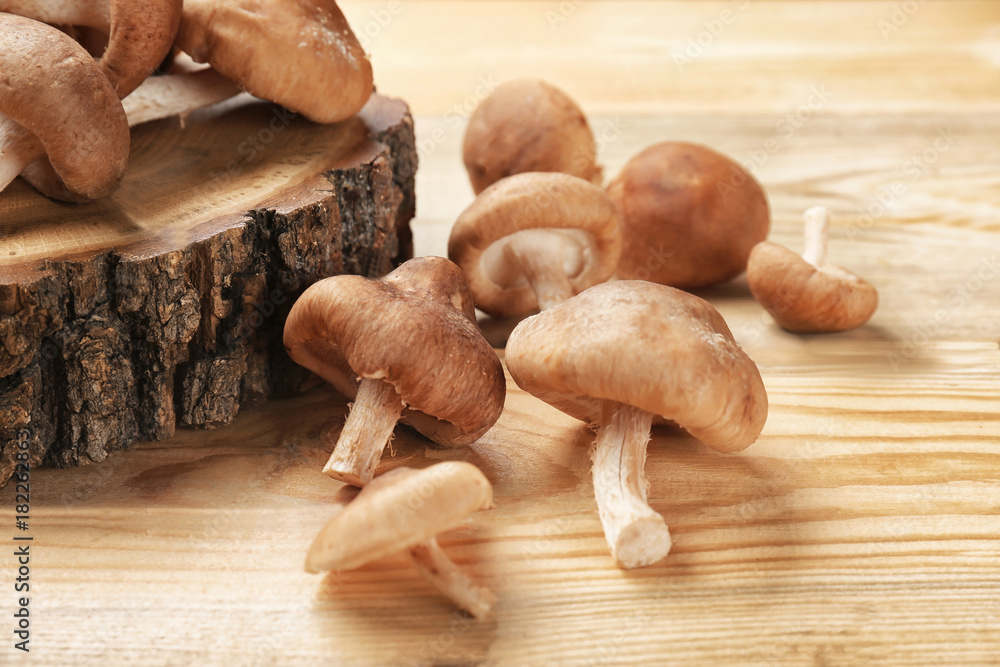 Raw shiitake mushrooms on wooden table, closeup Raw shiitake mushrooms on wooden table, closeup