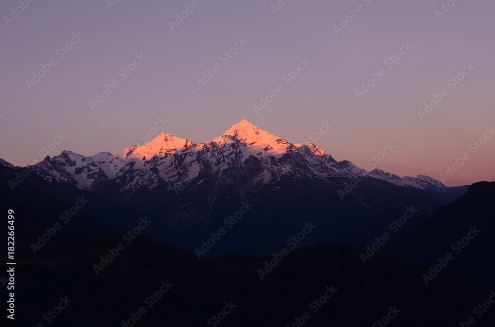 Peaks of the Caucasus Mountains on the background of purple sky