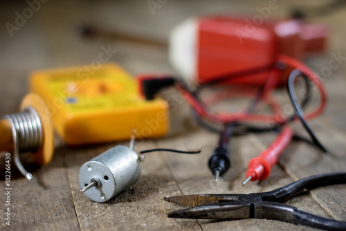 Electronic workshop. Electric meter and soldering iron.