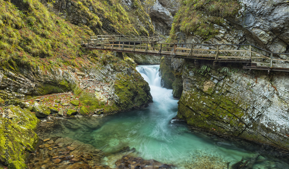 wooden bridge in canyon through big creek in Slovenia wooden bridge in canyon through big creek in Slovenia