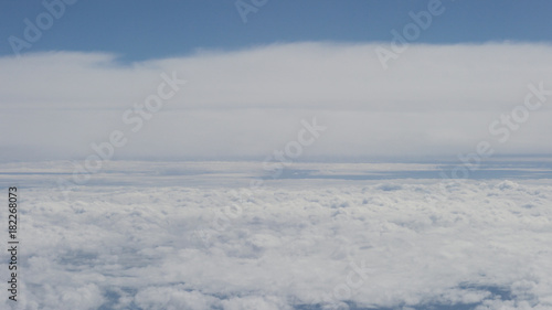 aerial shot from plane flying above the clouds in daytime © GCapture