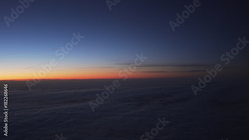 clouds in early morning during flight on a plane © GCapture