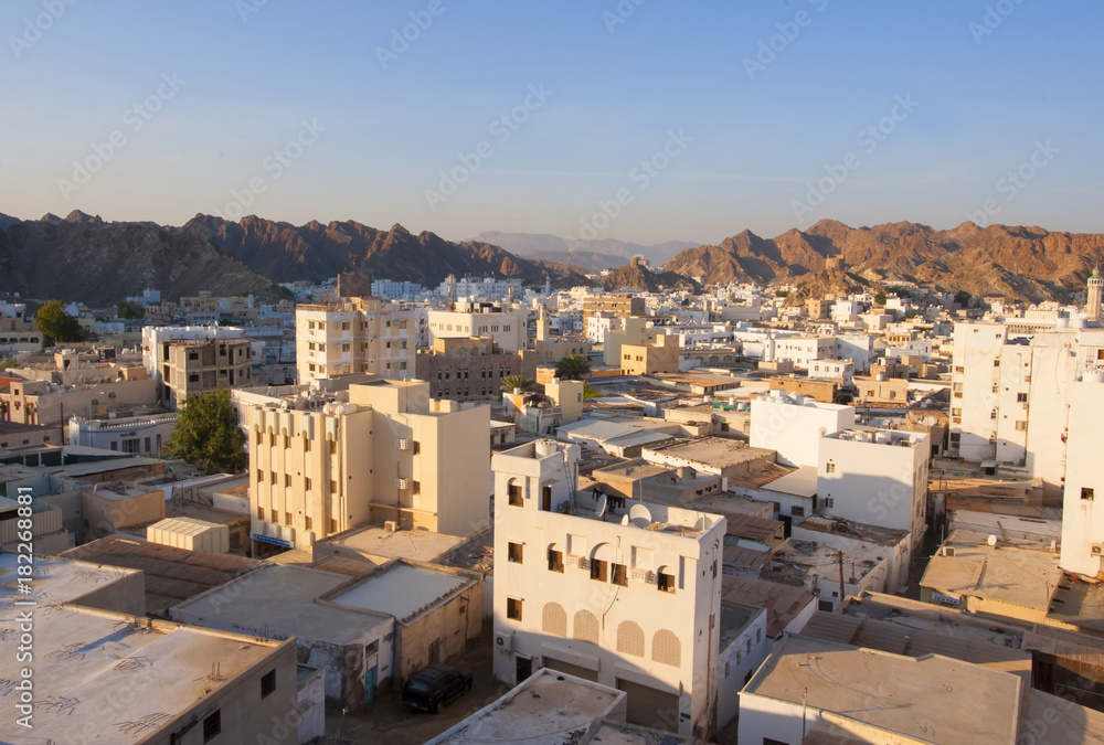 Oman. Muscat. The first rays of the sun fall on the Eastern city among the rocks.