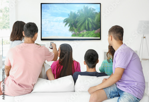 Friends watching TV at home
