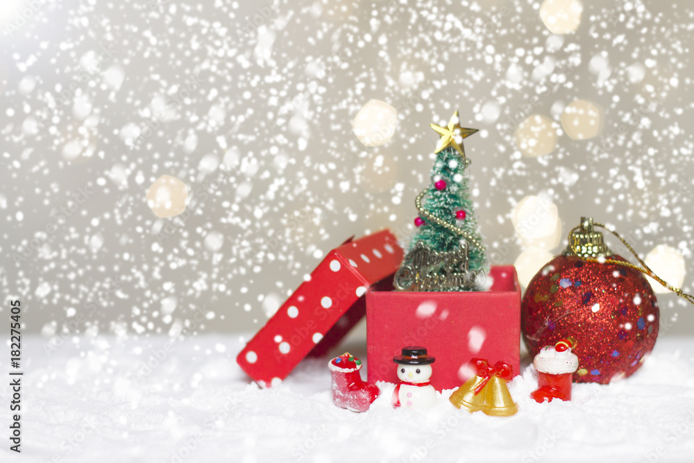 Miniature Christmas Santa cros and Tree on snow over blurred bokeh background,Decoration Image for Christmas Holiday and Happy New Year Gift box Celebration concept. Miniature Christmas Santa cros and Tree on snow over blurred bokeh background,Decoration Image for Christmas Holiday and Happy New Year Gift box Celebration concept.