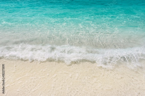 Teal blue warm sea waves shallow on white sand. Tropical beach seaside vacations. Laccadive sea resort. 