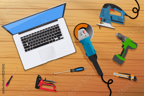 Home computer and home tools on wooden table top view