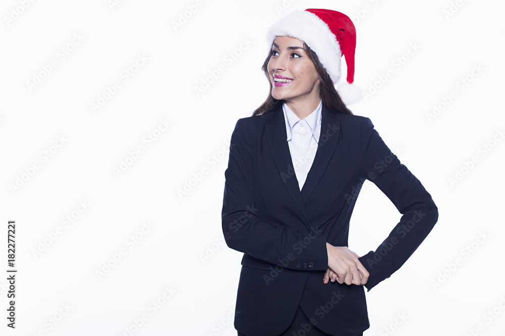 Happy holidays to you. New Year in the office. Beautiful young smiling business woman in santa hat on a white background. New Year and Christmas at work. Happy holidays to you. New Year in the office. Beautiful young smiling business woman in santa hat on a white background. New Year and Christmas at work.