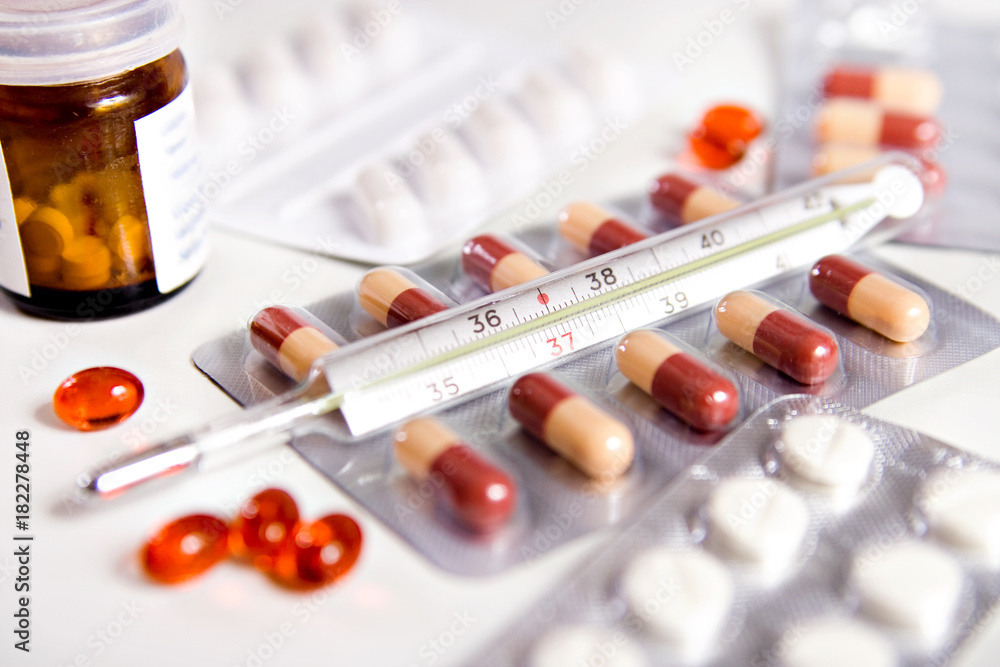 Pills Drugs and Thermometer, Red Tablets Capsule on White, Health and Medicine Concept Pills Drugs and Thermometer, Red Tablets Capsule on White, Health and Medicine Concept