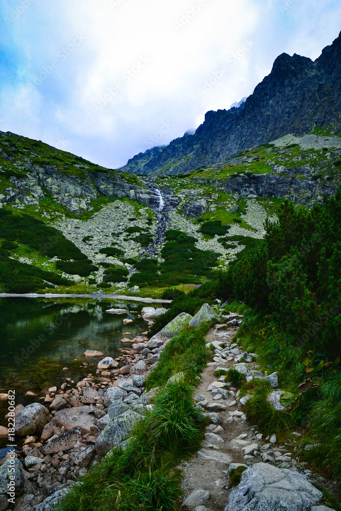 Fototapeta premium mountain landscape by the sidewalk towards the waterfall