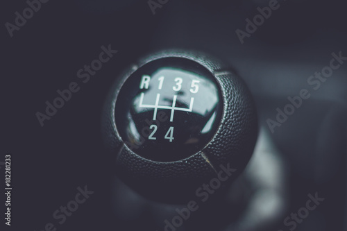 Manual shifting gear stick on black dark background.