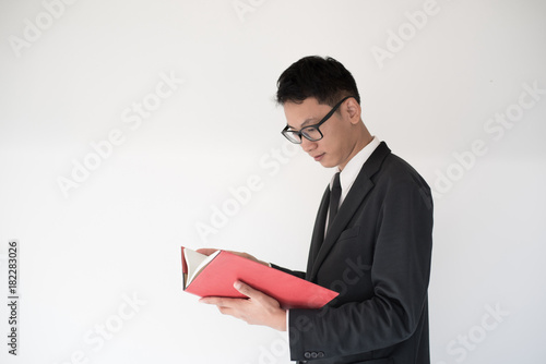 pensive business man Reading Book and smile on white background
