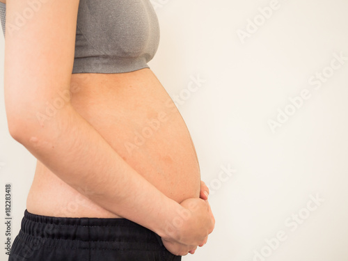 Pregnant woman in sport bar. Pregnant woman holds her hands on belly. belly pregnent woman.