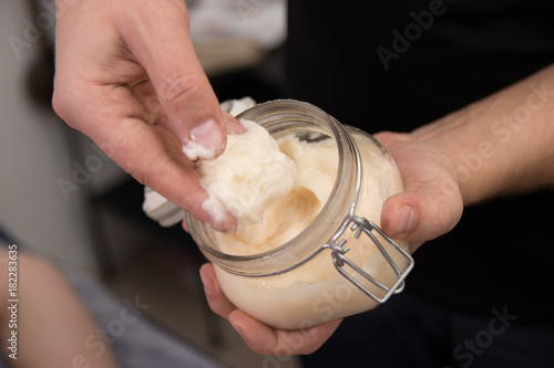 male hands doing professional massage to a woman with honey