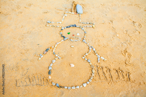 Snowman of rock in  Sand on beach